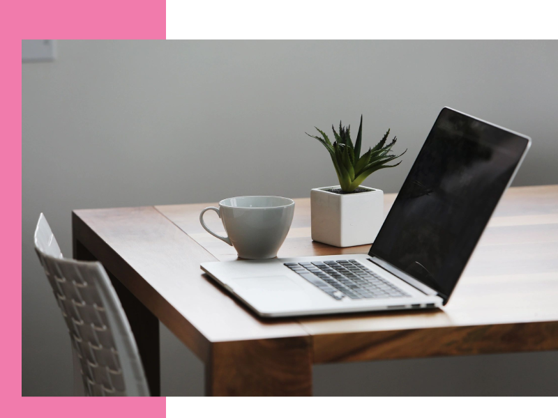 A laptop and cup on a table